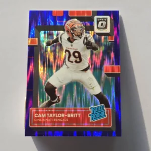 Panini Donruss Optic Football 2022 | #271 Cam Taylor-Britt - Cincinnati Bengals | Rated Rookie Purple Shock Prizm
